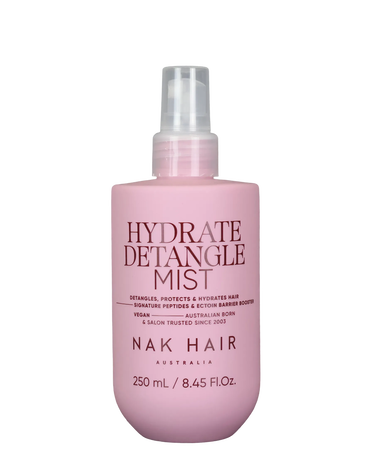 NAK Hair Hydrate Detangle Mist 250mL in a matte pink spray bottle with a clear pump nozzle.
