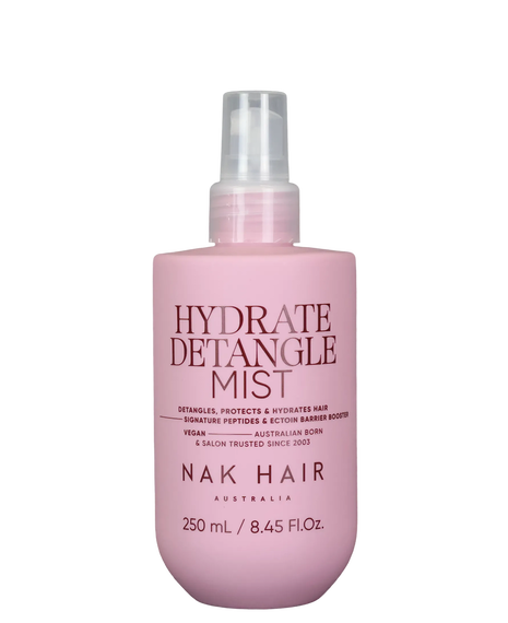 NAK Hair Hydrate Detangle Mist 250mL in a matte pink spray bottle with a clear pump nozzle.